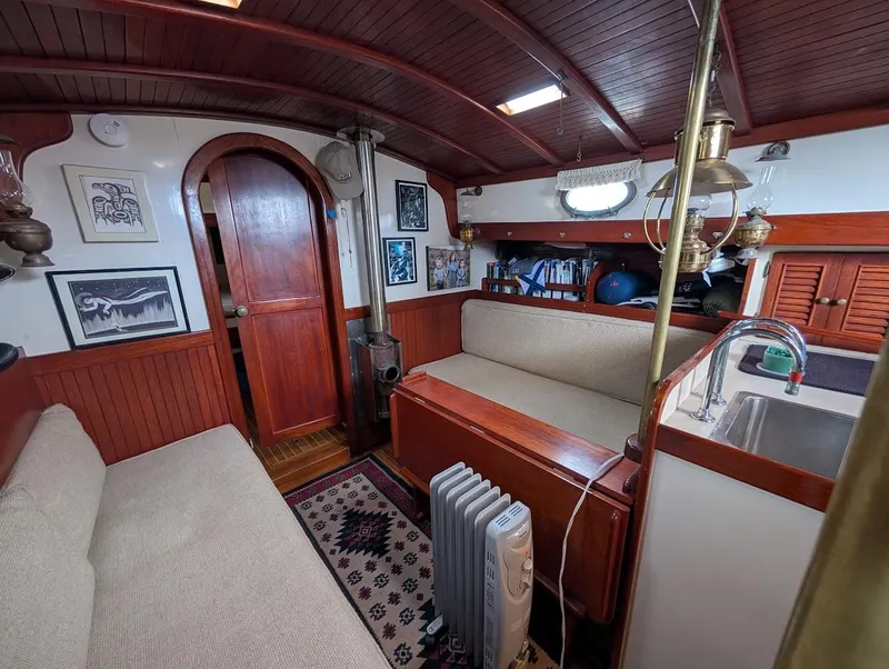Slide: The Image of Interior of 1977 Alajuela 38 Mk1 sailboat with wooden furnishings and cozy seating area. - 25