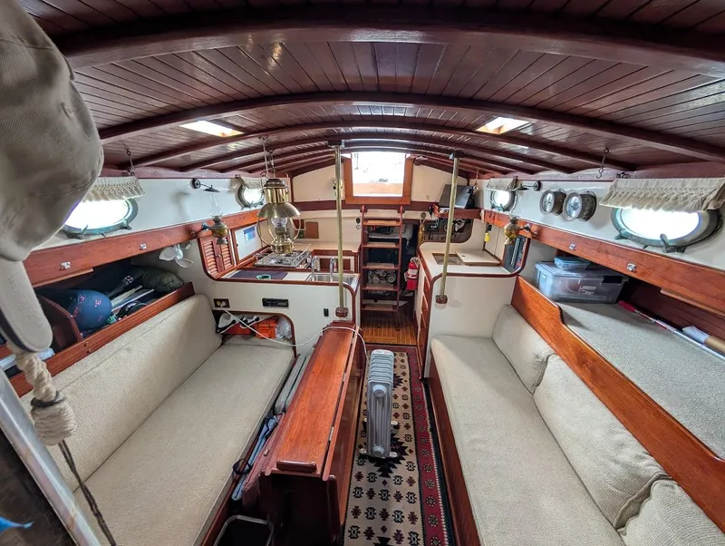 Slide: The Image of Interior of a 1977 Alajuela 38 Mk1 sailboat with wooden finishes and cozy seating. - 26