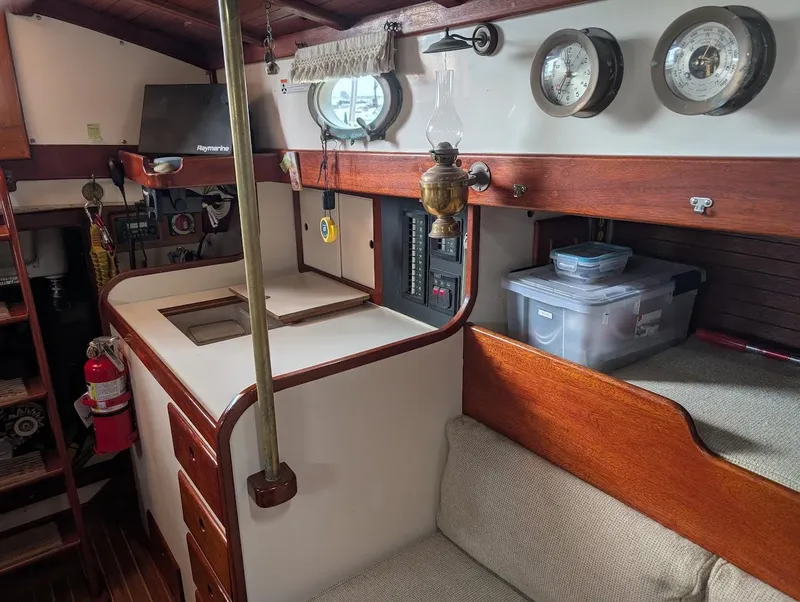 Slide: The Image of Interior of a 1977 Alajuela 38 Mk1 sailboat with wooden accents and nautical decor. - 28