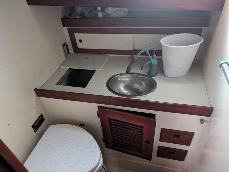 Slide: The Image of 1977 Alajuela 38 Mk1 boat bathroom with sink, toilet, and storage cabinets. - 32