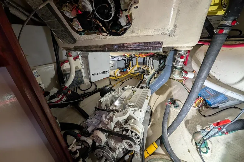 Slide: The Image of Engine room of a 1977 Alajuela 38 Mk1 sailboat, showcasing mechanical components and wiring. - 36