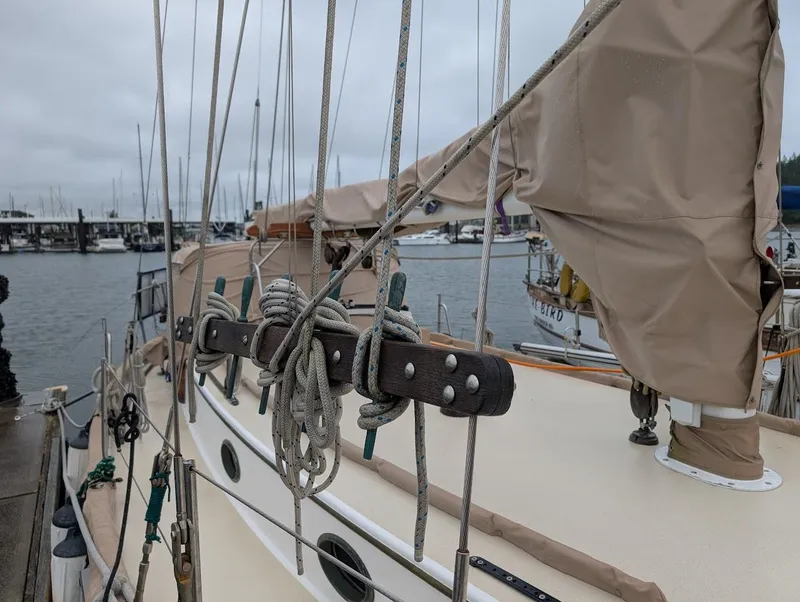 Slide: The Image of 1977 Alajuela 38 Mk1 sailboat with rigging and covered sails at a marina. - 6