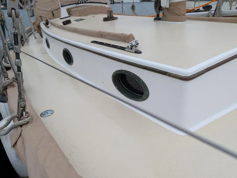 Slide: The Image of 1977 Alajuela 38 Mk1 sailboat deck with portholes and beige covers. - 7