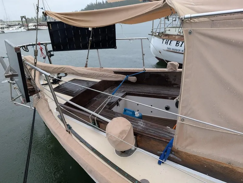 Slide: The Image of 1977 Alajuela 38 Mk1 sailboat with beige canopy docked in a marina. - 8