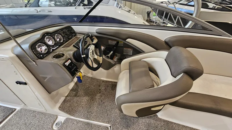 Slide: The Image of 2011 Yamaha Boats 242 Limited S interior with steering wheel and dashboard controls. - 11