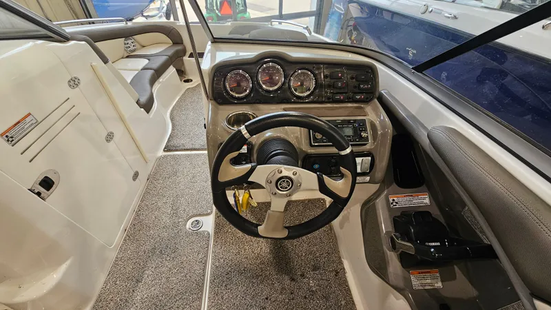 Slide: The Image of 2011 Yamaha Boats 242 Limited S cockpit with steering wheel and dashboard controls. - 12