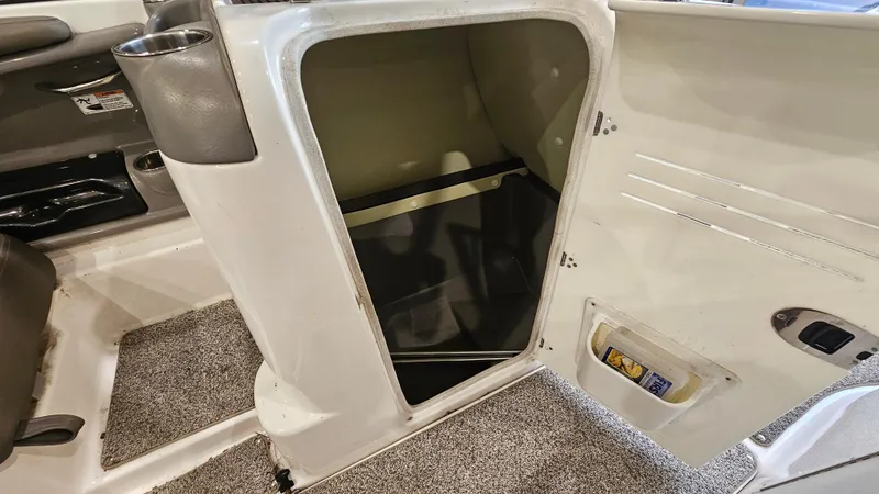 Slide: The Image of 2011 Yamaha Boats 242 Limited S interior storage compartment with open door. - 18