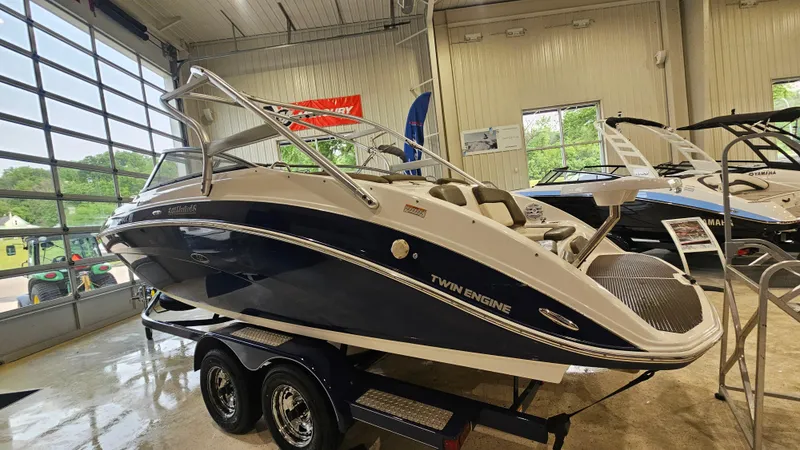Slide: The Image of 2011 Yamaha Boats 242 Limited S in showroom, twin engine, sleek design, on trailer. - 4
