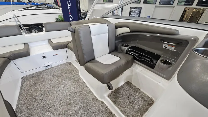 Slide: The Image of Interior of 2011 Yamaha Boats 242 Limited S, featuring gray and white seating and carpeted flooring. - 9