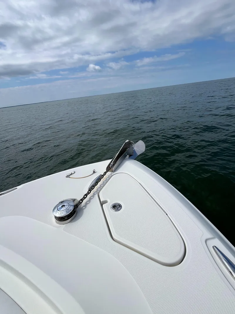 Slide: The Image of 2019 HCB Siesta boat on open water under cloudy sky. - 10