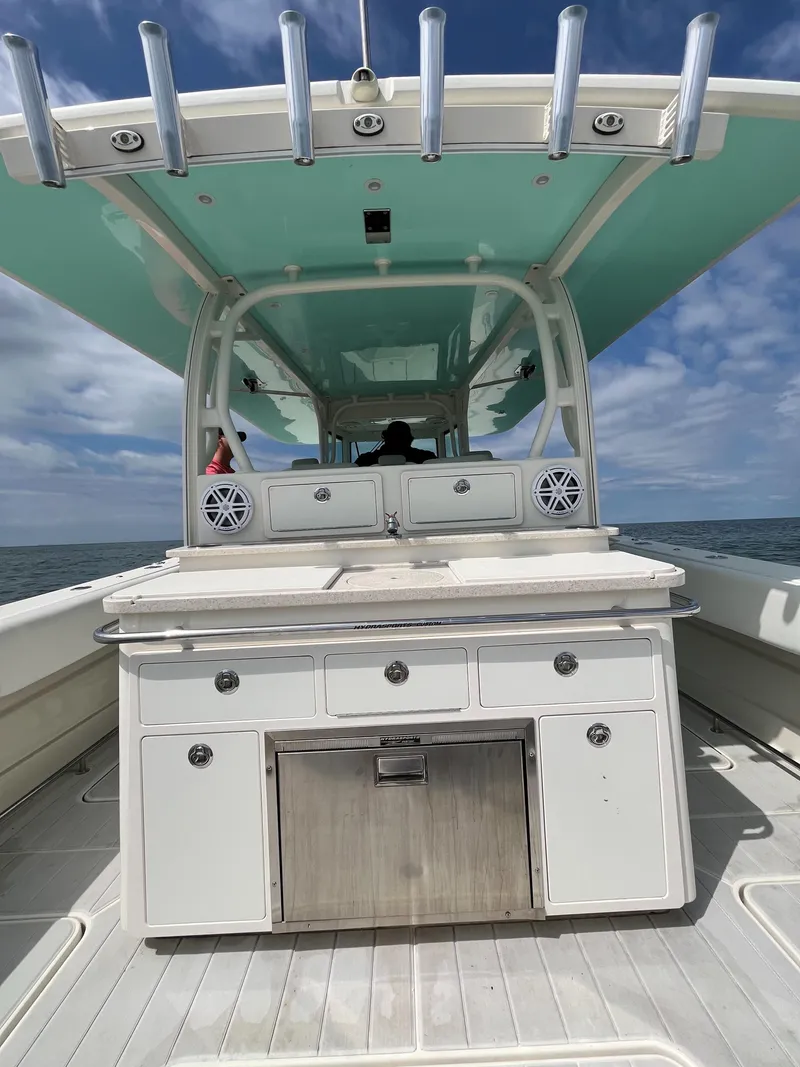 Slide: The Image of 2019 HCB Siesta boat with a spacious deck and modern amenities on open water. - 14