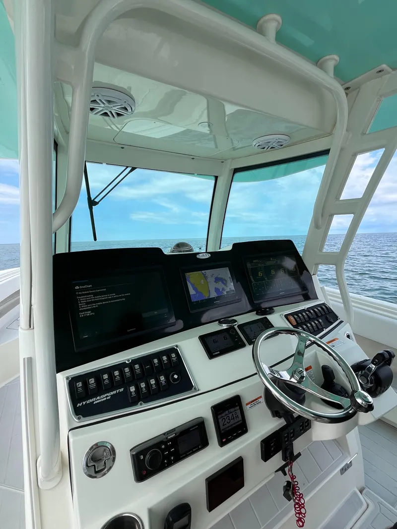 Slide: The Image of 2019 HCB Siesta boat helm with advanced navigation system and ocean view. - 16