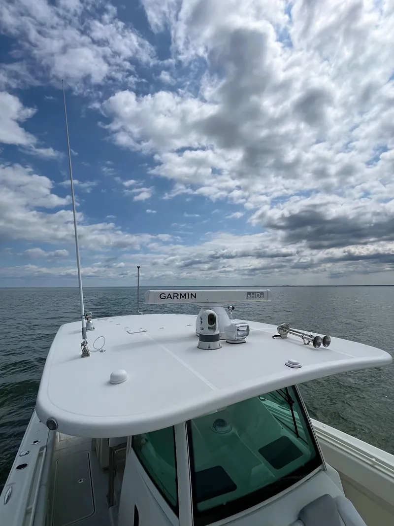 Slide: The Image of 2019 HCB Siesta boat with Garmin equipment on open water under cloudy sky. - 18