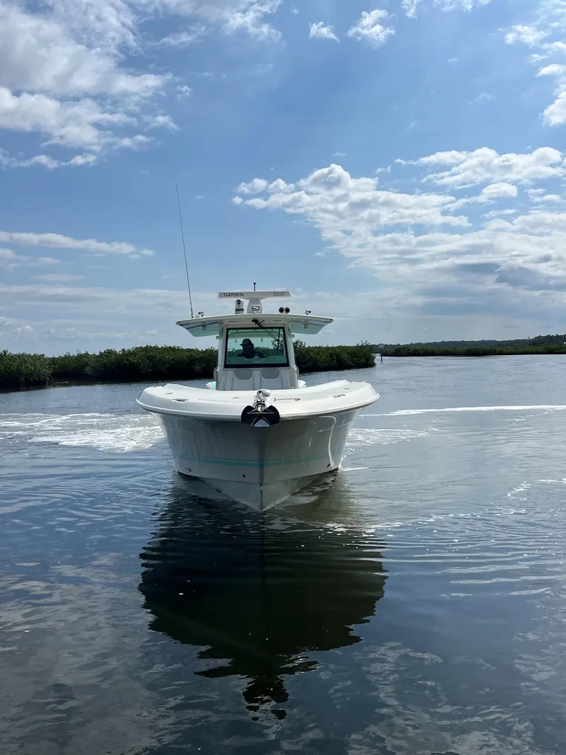 Slide: The Image of 2019 HCB Siesta boat cruising on calm water under a partly cloudy sky. - 3