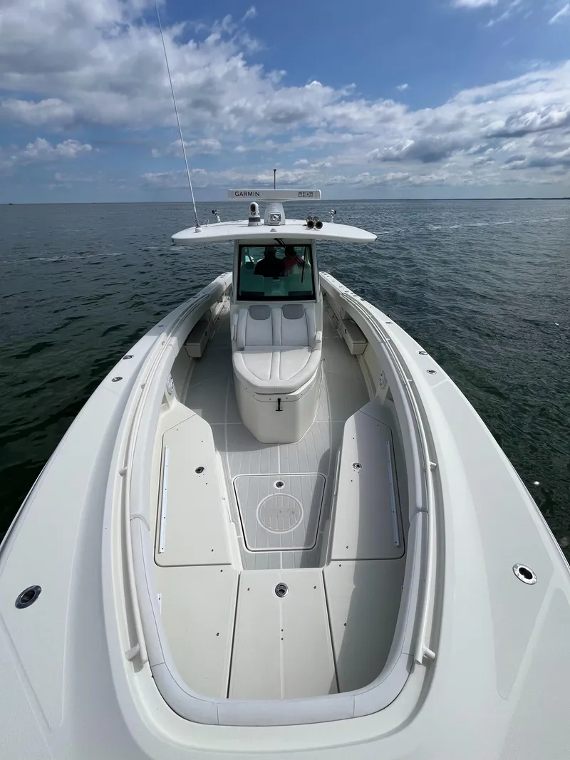 Slide: The Image of 2019 HCB Siesta boat on open water under a partly cloudy sky. - 4