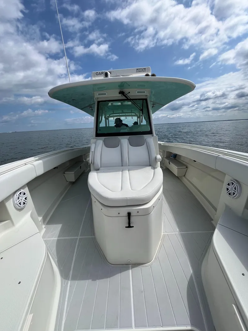 Slide: The Image of 2019 HCB Siesta boat on open water under a partly cloudy sky. - 7