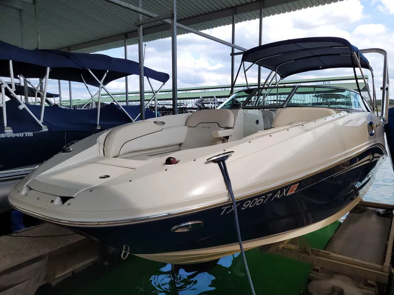 The Image of 2008 Sea Ray 260 Sundeck boat docked under a covered marina. - 0