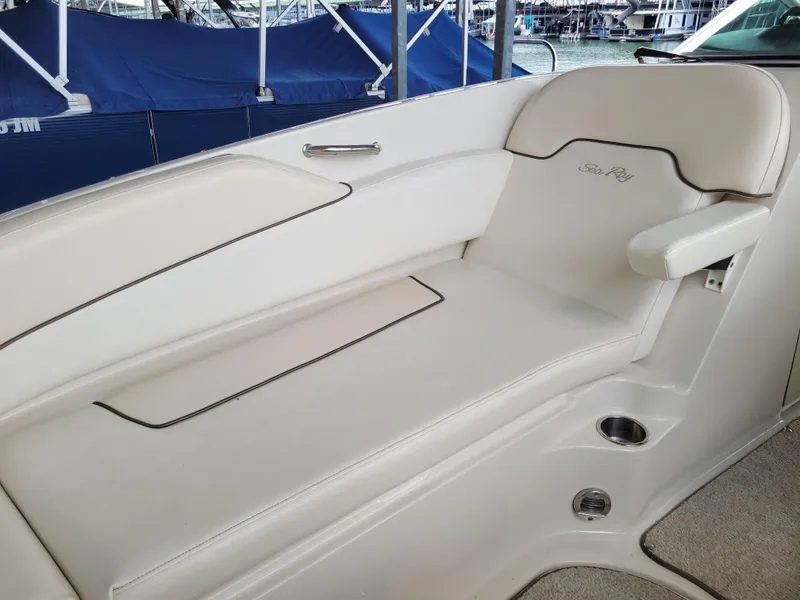 Slide: The Image of 2008 Sea Ray 260 Sundeck interior seating with white upholstery and cup holders. - 12