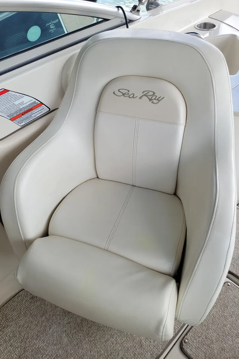 Slide: The Image of 2008 Sea Ray 260 Sundeck boat seat with white upholstery and embroidered logo. - 15