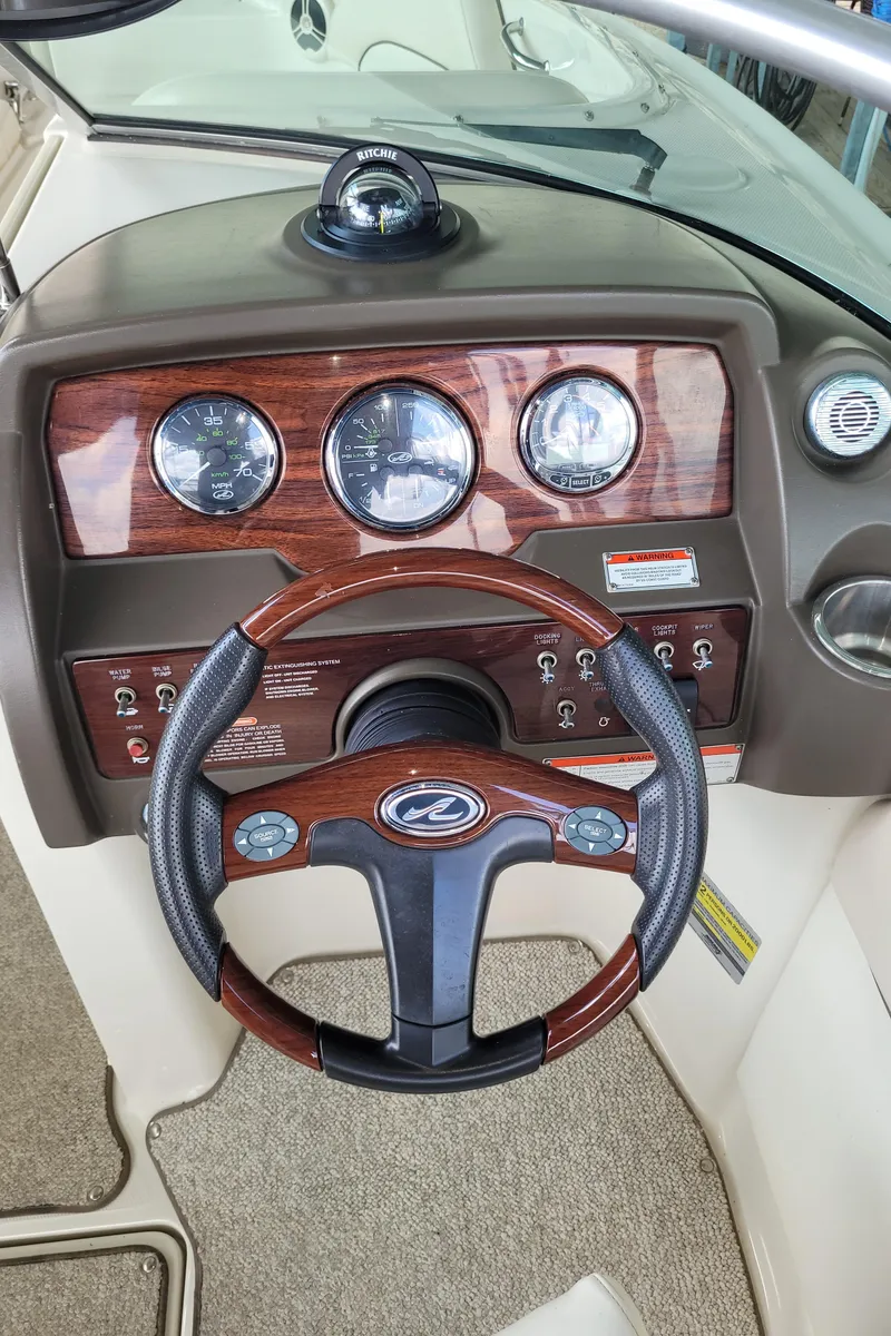Slide: The Image of Steering wheel and dashboard of a 2008 Sea Ray 260 Sundeck boat. - 16