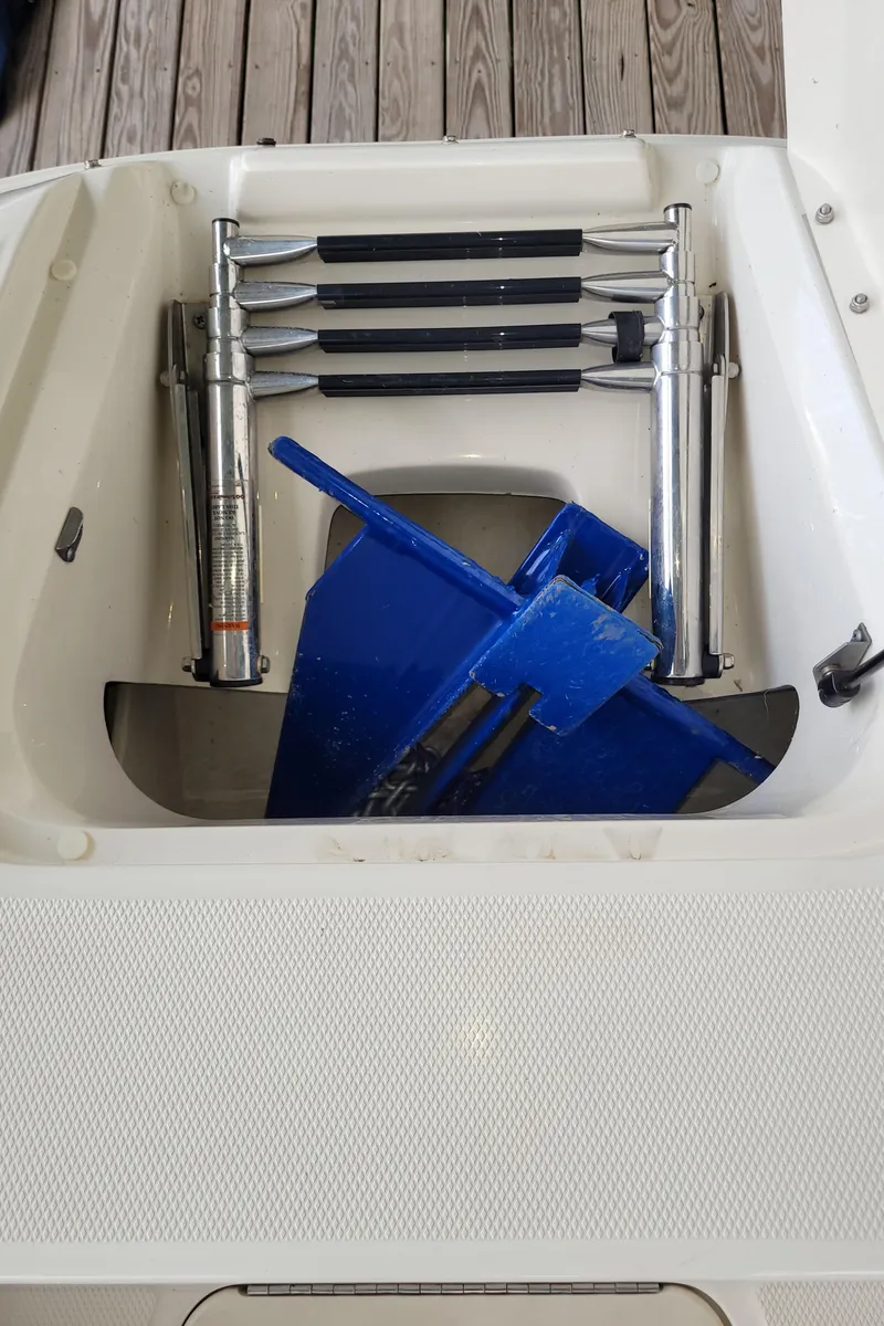 Slide: The Image of 2008 Sea Ray 260 Sundeck storage compartment with ladder and blue anchor. - 22