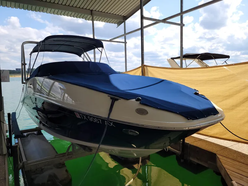 Slide: The Image of 2008 Sea Ray 260 Sundeck boat docked under a canopy on a sunny day. - 23