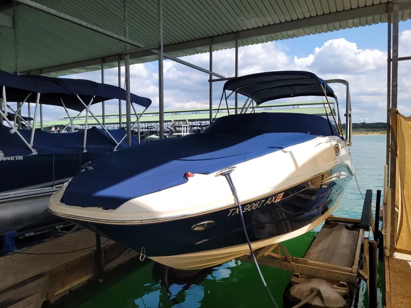 Slide: The Image of 2008 Sea Ray 260 Sundeck boat docked under a covered marina. - 24