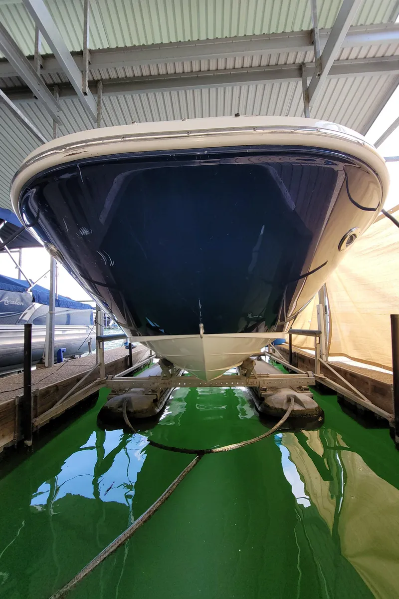 Slide: The Image of 2008 Sea Ray 260 Sundeck boat docked in a covered marina. - 28