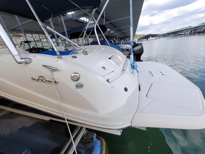 Slide: The Image of 2008 Sea Ray 260 Sundeck boat docked at marina, featuring spacious deck and sleek design. - 3