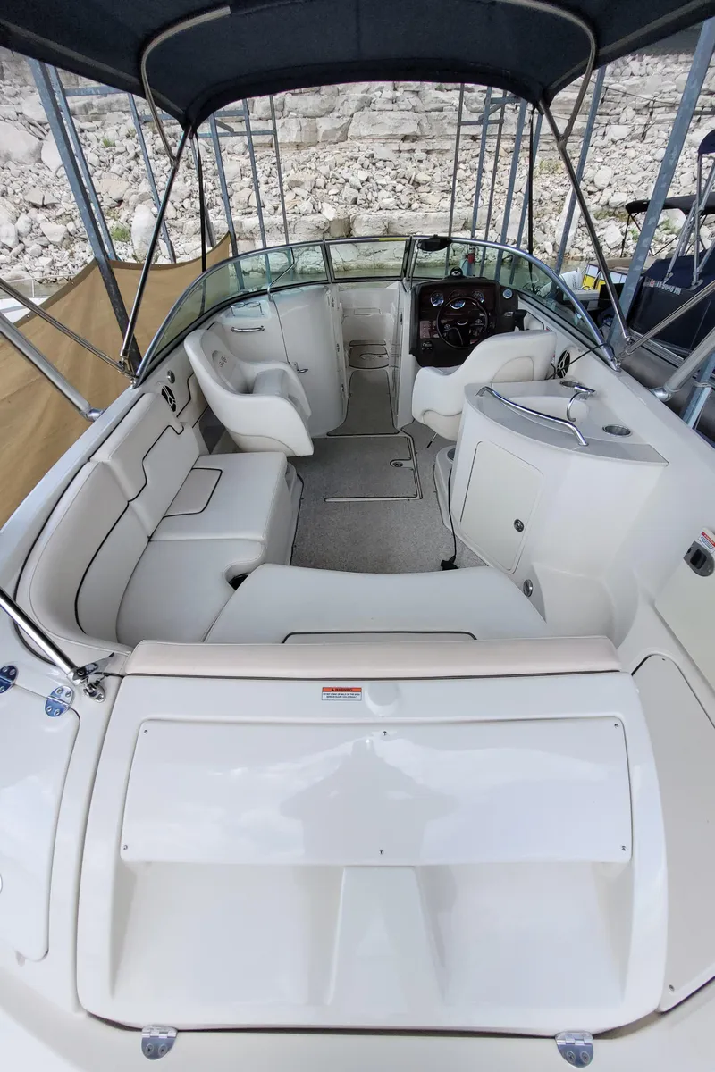 Slide: The Image of 2008 Sea Ray 260 Sundeck boat interior with seating and helm, under a canopy. - 5