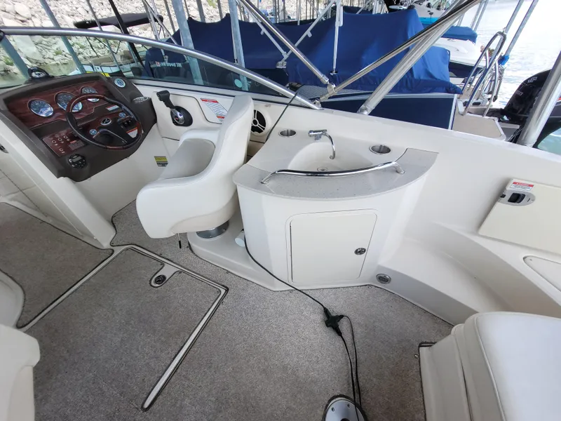 Slide: The Image of 2008 Sea Ray 260 Sundeck interior with helm, sink, and seating area. - 7