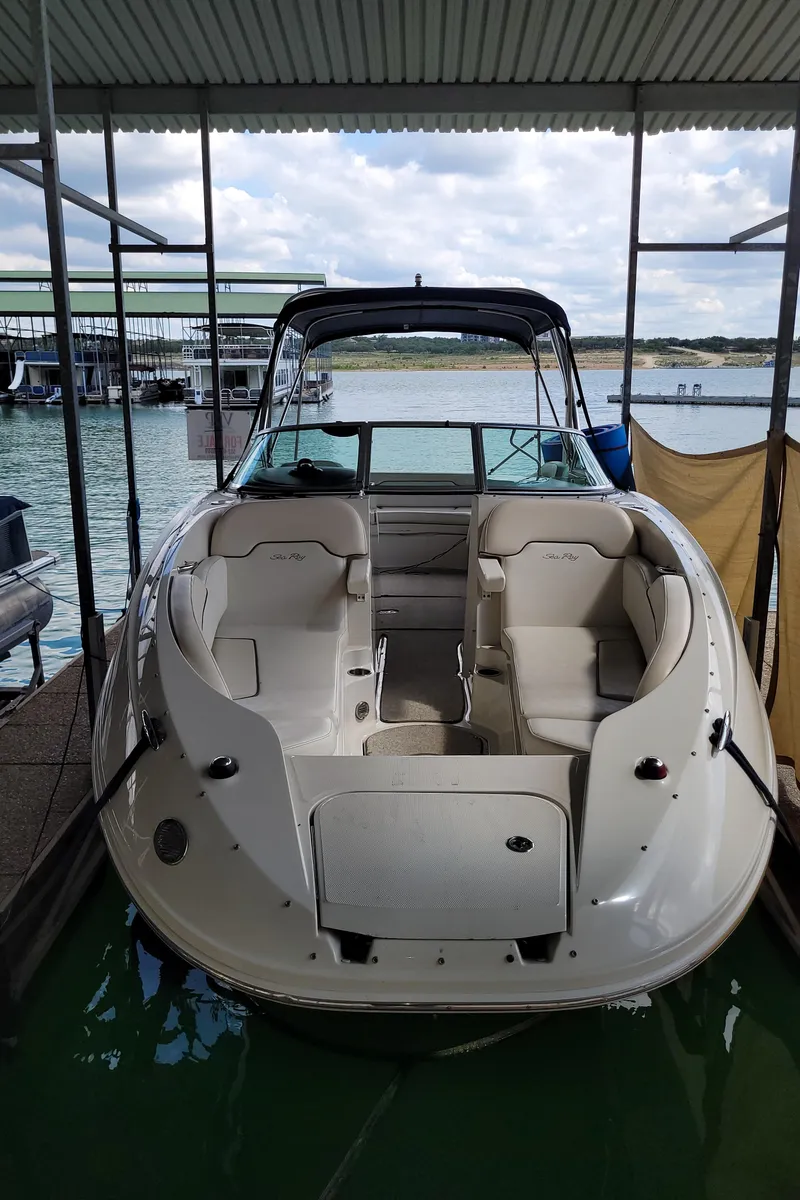 Slide: The Image of 2008 Sea Ray 260 Sundeck boat docked under a covered marina. - 8