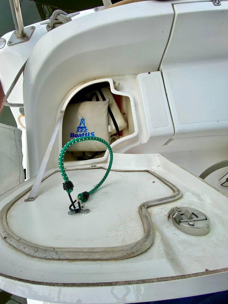 Slide: The Image of 2008 Hunter 36-2 sailboat cockpit with storage compartment and coiled green rope. - 15