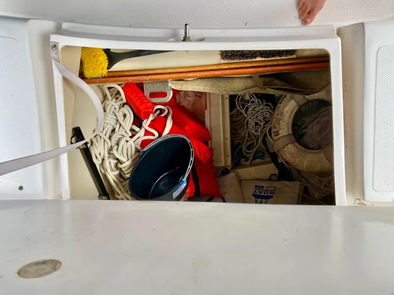Slide: The Image of Storage compartment on a 2008 Hunter 36-2 sailboat with ropes, life jacket, and bucket. - 22