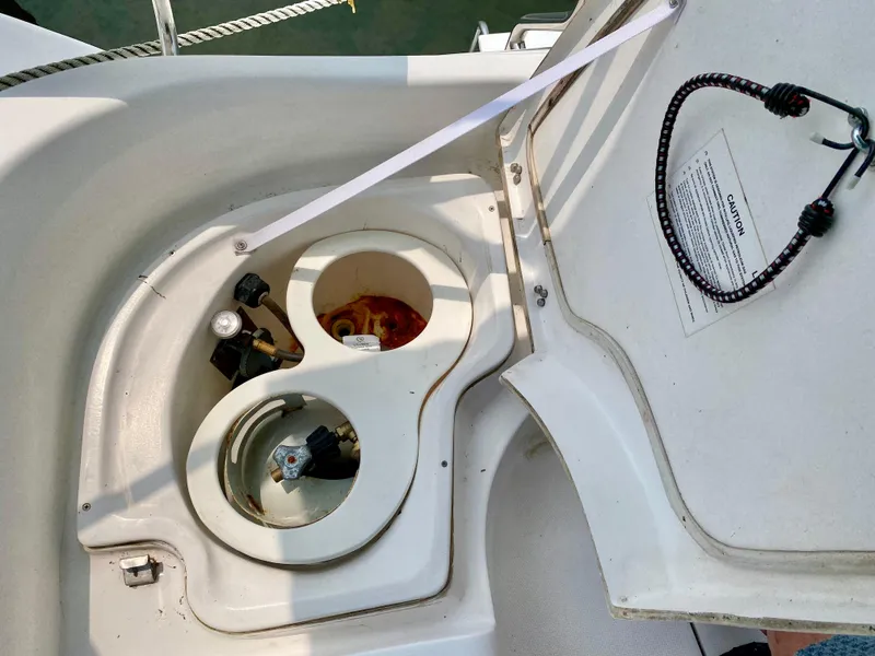 Slide: The Image of Open storage compartment on a 2008 Hunter 36-2 sailboat, showing utility connections. - 25