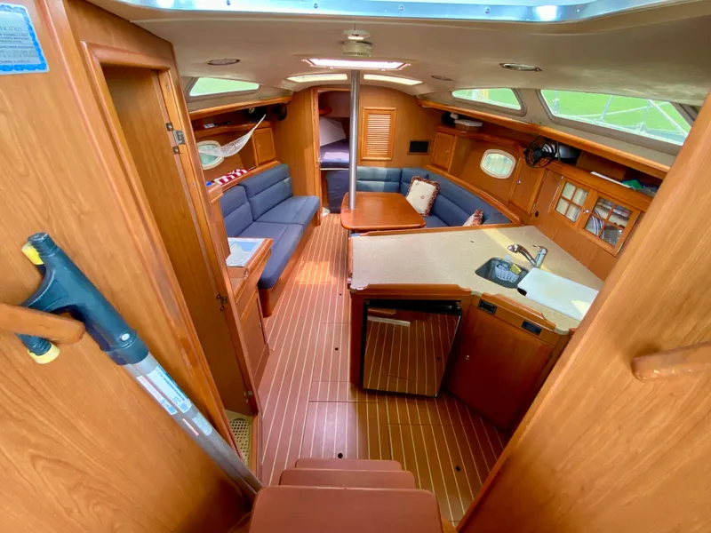 Slide: The Image of Interior of 2008 Hunter 36-2 sailboat with wood finish and blue seating. - 30