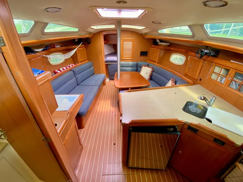 Slide: The Image of Interior of 2008 Hunter 36-2 sailboat with wood finish and blue seating. - 32