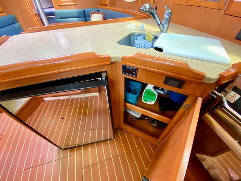 Slide: The Image of 2008 Hunter 36-2 yacht kitchen with sink, fridge, and storage cabinets. - 33