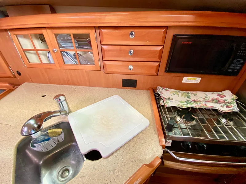Slide: The Image of Galley kitchen in 2008 Hunter 36-2 sailboat with sink, stove, and microwave. - 34