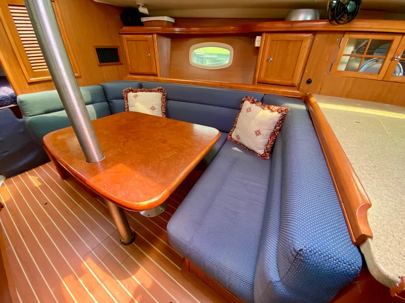 Slide: The Image of Cozy interior of 2008 Hunter 36-2 sailboat with wooden table and blue seating. - 39