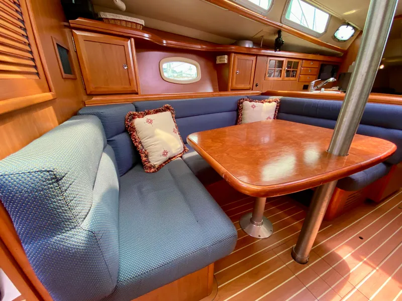 Slide: The Image of Interior of 2008 Hunter 36-2 sailboat with blue seating and wooden table. - 40