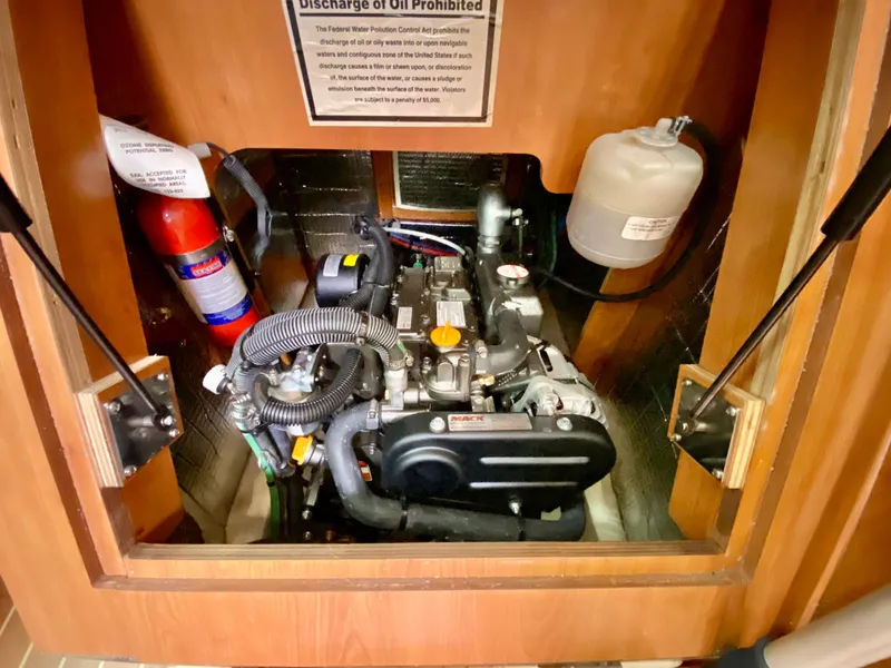 Slide: The Image of Engine compartment of a 2008 Hunter 36-2 sailboat, featuring a well-maintained engine and safety equipment. - 42