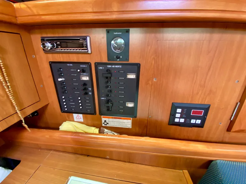 Slide: The Image of Control panel of a 2008 Hunter 36-2 sailboat with wood finish and electronic controls. - 43