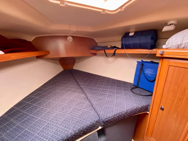 Slide: The Image of 2008 Hunter 36-2 sailboat cabin with cozy V-berth and storage. - 45