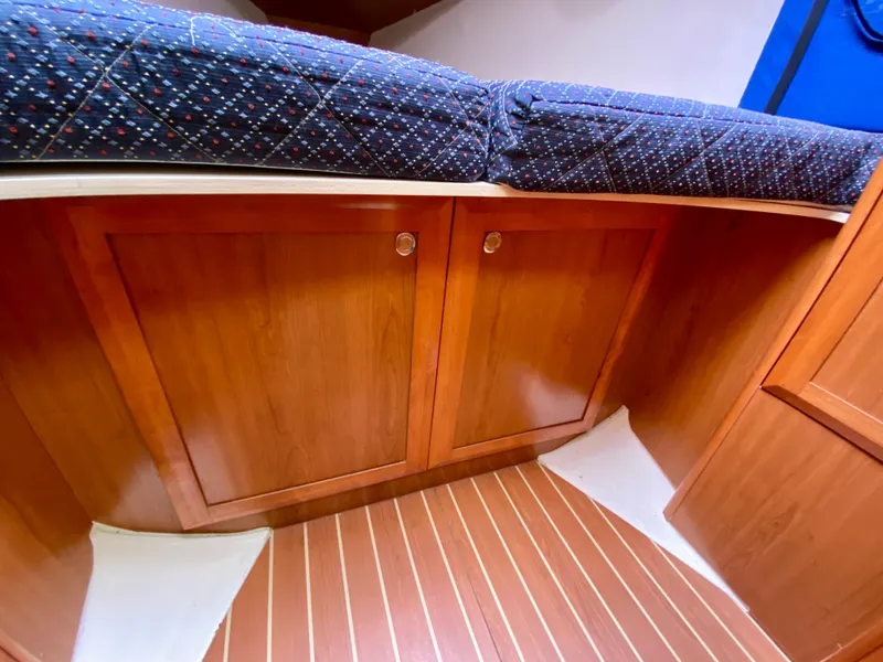 Slide: The Image of 2008 Hunter 36-2 yacht interior with wooden cabinets and patterned upholstery. - 46