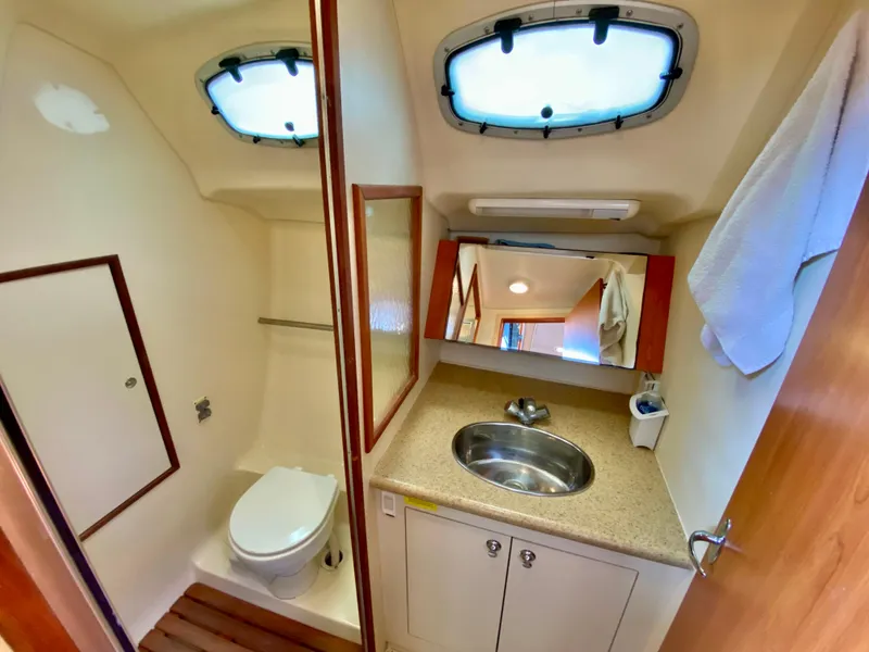 Slide: The Image of Compact bathroom in a 2008 Hunter 36-2 yacht with sink, toilet, and mirror. - 49