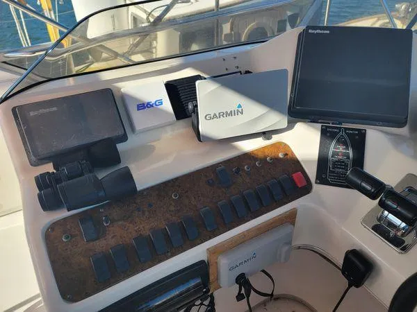 Slide: The Image of Control panel of a 1995 Sea Ray 440 Express Bridge with Garmin and Raytheon equipment. - 11
