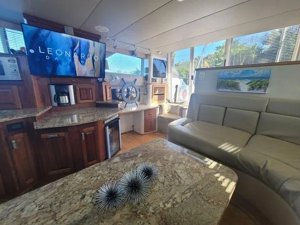 Slide: The Image of Luxurious interior of 1995 Sea Ray 440 Express Bridge with modern amenities and elegant design. - 14