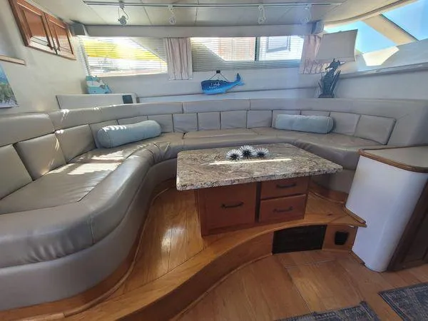 Slide: The Image of Luxurious interior of 1995 Sea Ray 440 Express Bridge with plush seating and elegant decor. - 15
