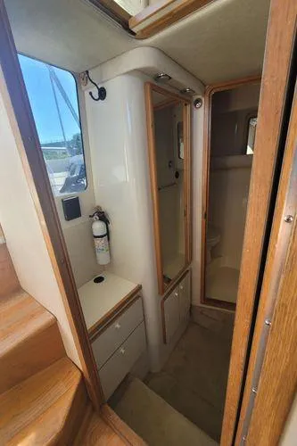 Slide: The Image of Interior view of 1995 Sea Ray 440 Express Bridge yacht, featuring stairs and cabinetry. - 20